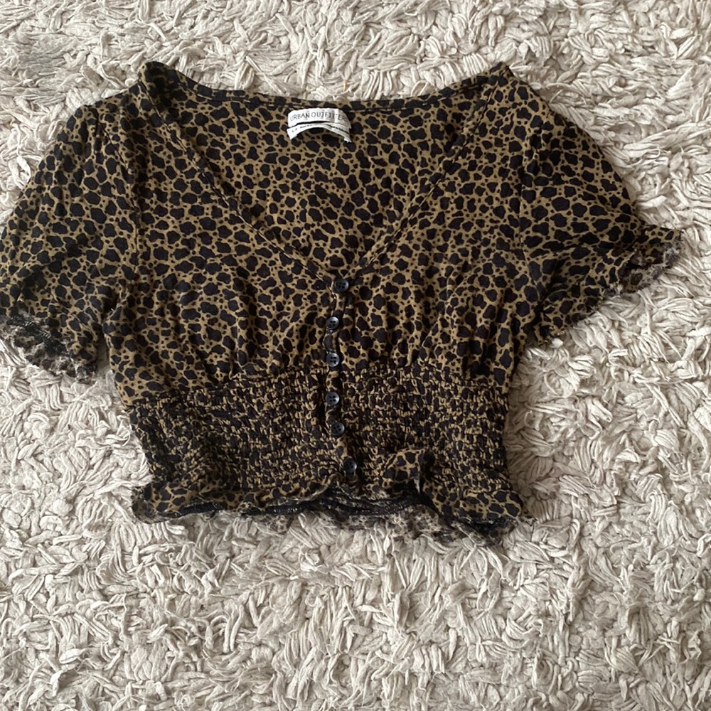 Urban cheetah print top. Fits so well and cute detailing on bottom